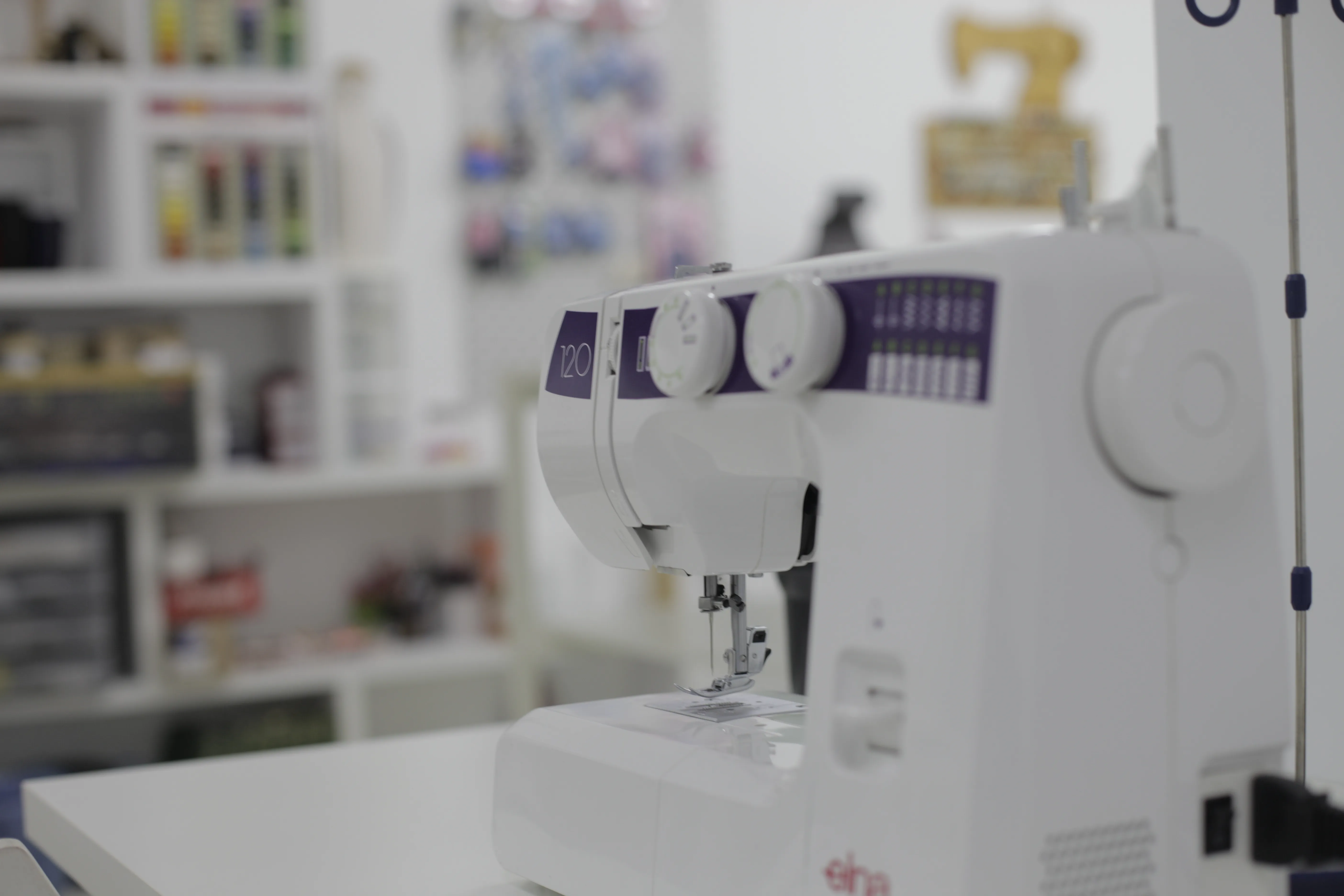 Máquina de coser del aula de la Escuela Tresele con estantería de fondo